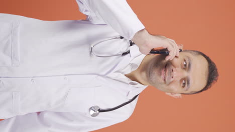 Vertical-video-of-The-doctor-is-talking-on-the-phone.